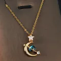 Detailed view of a gold fantasy planet necklace featuring moon and star zircon pendants - Dreamy Star Moon Star