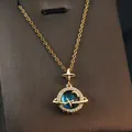 Detailed view of dreamy planet pendant necklace with shimmering zircons and stars. - Dreamy Planet
