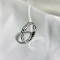 Detailed view of the double-row pavé starry ring with sparkling cubic zirconia on white silk. - 5 / Silver