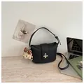 Elegant black textured leather bucket bag with silver clasp and cute bear charm. - With Pendant / Black