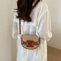 Handmade straw woven crossbody saddle bag with brown leather straps and gold hardware - Brown