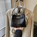 Elegant black lychee grain bucket bag with silver turn-lock and adjustable crossbody strap - No Pendant / Black
