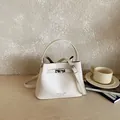 Premium white textured leather bucket bag with top handle and crossbody strap - No Pendant / White