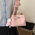 Stylish pink pebble textured bucket handbag featuring a cute bear charm and metal lock detail. - With Pendant / Pink