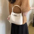 Elegant cream lychee pattern bucket handbag for women with metallic twist lock - With Pendant / White
