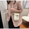 Elegant white mini crossbody phone bag for women featuring a stylish wooden toggle clasp - Pearly White