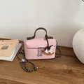 Elegante rosa Lederhandtasche mit süßem Schaukelpferd-Anhänger und Kettenriemen - Stil mit Anhänger / Rosa