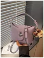 Detail of a purple textured leather bucket bag with a cute bear charm and twist lock. - With Pendant / Purple