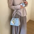 Sparkling light blue rhinestone bucket bag featuring a pearl tulip charm and chain strap - Blue With Pendant
