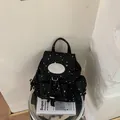 Trendy black canvas backpack featuring white star patterns and a top handle strap - Standard Type / Black