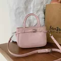 Elegant small pink textured faux leather crossbody bag with top handle and buckle detail - Standard Type / Pink