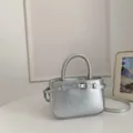 Elegant silver textured leather bucket bag with top handle and crossbody strap - Standard Type / Silver