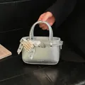 Sophisticated silver textured leather bucket bag with elegant pearl heart charm accessory - Pearl Charm Style / Silver