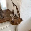 Modern brown faux leather underarm shoulder bag featuring silver buckle and side pocket detail - No Pendant / Brown