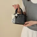 Elegant black bucket handbag with a pearl lace bow charm detail for daily wear - Pearl Charm Style / Black