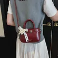Elegant dark red small handbag featuring a pearl lace bow and adjustable crossbody strap - Pearl Charm Style / Red