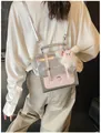 Silver metallic Korean style backpack with pink polka dots and plush bunny charm worn by a model - Silver