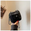 Elegant black quilted box bag featuring silver chain strap and camellia zipper pull - S / Black