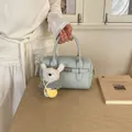 Stylish light blue lychee texture bowling handbag featuring a cute teddy bear charm - With Pendant / Blue