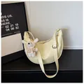 Detail view of yellow crescent dumpling bag with cute plush bear keychain charm - Yellow With Pendant / Yellow