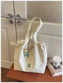 Large capacity cream canvas tote bag with drawstring design and cute doll charm. - No Pendant / White