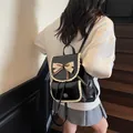 Elegant black faux leather backpack for women featuring lace trim and a cute bow detail. - Black