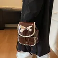 Vintage brown faux leather backpack featuring chic cream lace trim and a delicate bow tie - Coffee