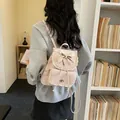 Elegant light pink backpack for women featuring delicate lace trim and sweet bow detail - Pink