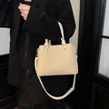 Elegant beige bucket handbag with knotted handles and a crossbody strap for women. - Standard Type / White