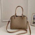 Stylish khaki bucket bag featuring a top handle and adjustable crossbody strap - Standard Type / Khaki