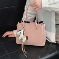 Elegant pink bucket bag with cute horse charm, versatile for shoulder or crossbody wear. - With Pendant / Pink