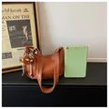 Brown faux leather shoulder bag with plush charm and tablet for size scale reference. - S / Yellow Brown