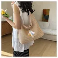 Detailed view of woven straw tote bag with girl embroidery on model's shoulder. - Style 2 (Cartoon Girl Embroidery) / Pink