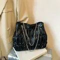 Large black pleated tote bag with silver chain shoulder strap for stylish women commuters - Black