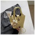 Detailed macro view of yellow lychee pattern handbag featuring a cute teddy bear charm - With Pendant / Yellow