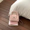 Elegant pink quilted handbag featuring a silver-tone lock, chain strap and top handle - No Pendant / Pink