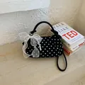 Elegant black polka dot handbag with pearl strap and white mesh bow accessory - Black
