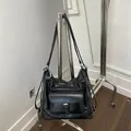 Versatile black large capacity women's tote bag hanging on a minimalist silver metal rack - Black