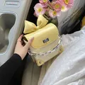 Stylish mini yellow crossbody bag featuring a decorative bow and thick silver chain strap - L / Yellow Large