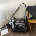 Black multi-functional large capacity shoulder bag with front pocket and flower charm. - With Charm / Black