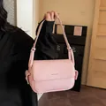Elegant pink pebbled leather underarm shoulder bag for women with minimalist brand lettering - Pink