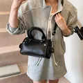 Elegant black lychee grain leather cylinder handbag for women with a shoulder strap - Black