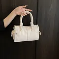 Elegant beige litchi grain handbag with unique pocket detail for women's daily commute - White