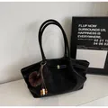 Vintage black pleated tote bag with plush charm on a minimalist background - Pendant Style / Black