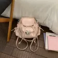 Sweet pink mini backpack for girls featuring a silver bow and adjustable straps - Pink