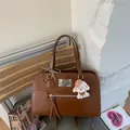 Vintage style brown faux leather commuter backpack with a cute puppy charm accessory - With Pendant / Brown
