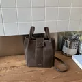 Dark brown bucket bag with contrast white stitching and top handle in vintage style - Basic Style / Coffee