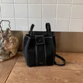 Elegant black suede bucket bag with white contrast stitching and adjustable shoulder strap - Basic Style / Black