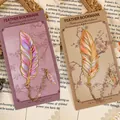 Elegant metal feather bookmarks featured in purple and orange gold variants for reading gifts - Evening Star and Rising Sun Feather