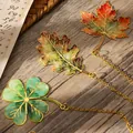 Detailed metal leaf bookmarks in maple, oak, and clover designs with elegant gold chains - Set of 3 / Maple And Clover And Oak